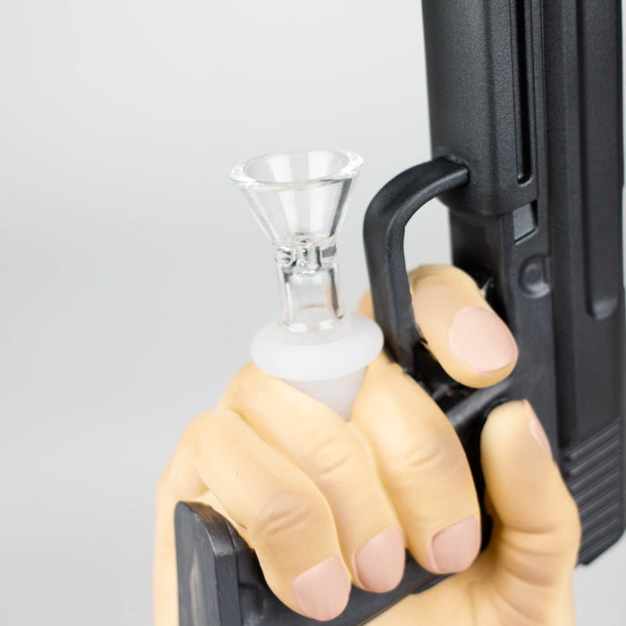 A bong with a pistol in hand